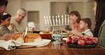 Home, hanukkah and menorah with family, dinner and conversation with food, love and bonding together. Tradition, parents and mother with father, children and kids with celebration, meal and candles