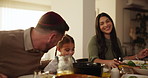 Eating, food and child with parents at dinner, celebration or together for Jewish event and meal. Girl, mom and dad talking in dining room with happiness on holiday for New Year party in home