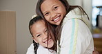 Sisters, face and happy with hug for love, house and care bonding in childhood as siblings with wellness support. Children, portrait and smile in embrace with gratitude, happiness together in home