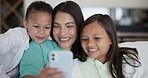 Mother, children and selfie in home for siblings love or bonding connection, social media or happy. Woman, daughters and digital device for smile online on post or relax holiday, support in lounge