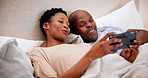Home, bed and black couple with a smartphone, love and morning with connection, smile and relax. Bedroom, man and woman with a cellphone, bonding together and happiness with a weekend break and app