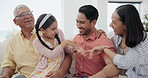 Happy, tickling and child with parents and grandfather on sofa in the living room together. Smile, laughing and girl kid playing with mother, father and senior man in the lounge at modern family home