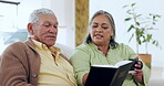 Bible, religion and a senior couple with a bible on the sofa of their home living room together for faith. God, drinking coffee and trust or faith in Jesus with a Christian man and woman in a house