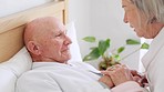 Bed, senior man and woman with love, care and support in retirement, home and calm morning. Old couple, holding hands and relax together in bedroom and talking about healthcare or help in house