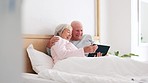 Senior, happy couple and together with tablet in bedroom with embrace, holding or hug. Man, woman and bond with laugh for funny joke, meme or post on social media by internet, web or network in home