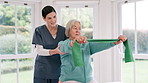 Woman, doctor and senior patient with resistance band in physiotherapy, fitness or exercise at old age home. Therapist or nurse helping mature female person in stretching, workout or therapy at house