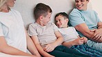 Happy, smile and parents with children in the bed talking, bonding and having fun together. Laughing, happiness and young mother and father relaxing with boy kids in bedroom of modern family home.