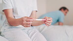 Woman, pregnancy test and hands for future, bedroom and anxiety or worry for healthcare. Couple, fail contraception and mistake for positive home maternity kit, fear or nervous thinking for baby