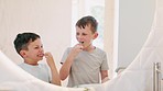 Morning, bathroom and children brushing teeth with toothpaste, toothbrush and learning self care. Cleaning, mouth and dental healthcare with kids together in mirror of family home with happiness