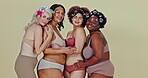 Diversity, flowers and happy women hug, body positive and together with self love, natural beauty and solidarity. Woman empowerment portrait, underwear and floral group support on studio background