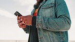 Beach, cellphone and closeup of man typing a text message or email on the internet or website. Technology, travel and male person networking on social media or mobile app with phone by ocean or sea.