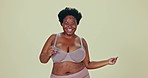 Dancing, body positivity and face of black woman in underwear in a studio for self love celebration. Happy, smile and portrait of young African female model moving with confidence by green background