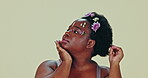 Face, beauty and flowers with a natural black woman in studio on gray background for skincare or wellness. Spa, aesthetic and a body positive young model looking confident at the salon for treatment
