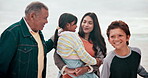 Big family, love and happy on beach with walking, travel and bonding on vacation, holiday or adventure by ocean. Interracial, parents and kids with grandpa at sea for experience, conversation or care