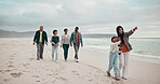 Big family, holding hands and beach walking for relax on cloudy day in connection, grandparents or children love. Mother, father and sea holiday time or bonding at ocean, point view or support care