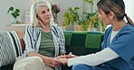 Senior care, old woman on sofa and nurse, holding hands for support and advice for healthcare in home. Homecare, elderly patient and caregiver in living room together for consultation, help and trust