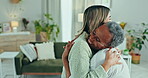 Senior woman, daughter and hug in home, care and bonding together in retirement. Adult, elderly mother embrace and support, comfort and smile, happy family and love of adopted person in living room.