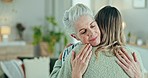 Love, comfort and woman hug senior mother in a living room with compassion, trust and empathy in their home. Mama, support and female person embrace elderly parent in a lounge with solidarity or care