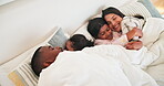 Family, parents and children wake up p in bed from above with love in the morning and relax together. Mother, father and cuddle with kids in the bedroom of home on a weekend, vacation or holiday