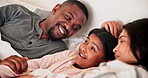 Parents, girl kid and bed with talking, smile and together with interracial love, care and bonding in house. Father, mother and daughter in bedroom, relax and conversation with hug at family home