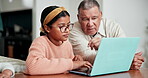 Grandparent, talking or child by laptop for education in living room, help and browse online with support. Senior man, girl or pc technology for remote learning, lesson subscription or love in home 