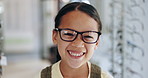Happy girl, kid and glasses for eyewear by shopping in optometrist office for corrective, lens and frame. Young person, excited and emoji with smile for choice with spectacles, eye care and health 
