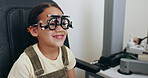 Eye exam, optometry and optician with frame for girl for testing vision, sight and glasses for child eyes. Healthcare, medical equipment and young patient with woman for prescription lens in clinic