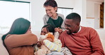 Happy, tickling and children with parents on a sofa in the living room of modern family home. Laughing, having fun and young kids playing with interracial mother and father in the lounge of house.