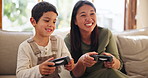 Video game, happy and mother with child on a sofa for gaming, playing and console fight at home together. Esports, gamer and family in a living room excited, having fun and bond in vacation freedom