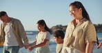 Beach, walking and parents holding hands with kids by sea for bonding, fun and relax in nature. Family, travel and mother, father and children by ocean on holiday, vacation and adventure together