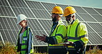 Team at solar panel plant for discussion, clean energy and outdoor electricity maintenance. Sustainability, photovoltaic power grid system and technician with engineer, planning and safety check.