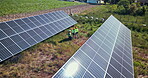 Drone, engineering or people with solar panels in nature for renewable energy, clean electricity or sustainability. Aerial view, employees or photovoltaic in a farm or outdoor for maintenance work
 
