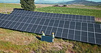 Drone, engineering or people with solar panels outdoor for renewable energy, clean electricity or sustainability. Aerial view, employees or photovoltaic in a farm or nature for maintenance or work
 
