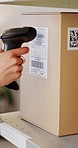 Hand, package or box with scanner for logistics, delivery or shipment of order in closeup. Small business, employee and inspection of price, barcode or information of inventory for customer in office