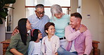 Happy, diversity and family hug in living room with love, care and support for together in wellness. Father, mom and kids with grandparents to relax, smile and generations bonding at home on vacation