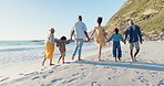 Beach, big family and rear view of holding hands while walking in nature for travel, love or freedom. Back, support and kids with parents and grandparents at the sea for summer, vacation or adventure