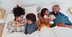 Happy family, kids and parents in bed, top view and talking together, bonding and support. African mother, father and children in bedroom above in conversation, interracial love and morning in home