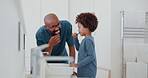 Child, learning and brushing teeth with dad in bathroom, morning and self care in family home. Teaching, grooming and father with kid in dental routine with toothpaste and toothbrush for oral health