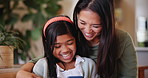 Mother, child and cellphone laughing in home for
online entertainment, learning or movie streaming. Indian girl, woman and video watching or scroll information for social media, smile funny or app
