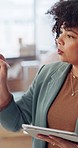 Tablet, planning and a business woman writing on a glass board in her office to brainstorm an idea. Technology, strategy or analysis and a young employee working with financial management documents