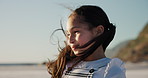 Thinking, kid and beach with wind, girl and vacation with seaside, holiday and adventure with happiness. Outdoor, child and travel with nature, summer break and weekend with fun, joy and relaxing