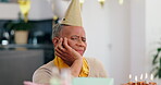 Birthday, senior woman and cake with depression, sad and bored with party, celebration and lonely feeling. Upset, emotion and unhappy with presents, alone or gifts with anxiety, pensioner or reaction