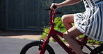 Youth, girl and bicycle for riding in street, neighborhood and outdoors for travel, fun or commute. Young person, active and learning of new skill in summer for childhood, memory or sport for joy