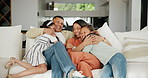 Family, hug and conversation on couch, happy and smiling at home, sofa and bonding together for love. Parents and children, embrace and relax or affection, care and quality time or smiling in cuddle