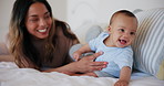 Happy, mom and baby wake up in bed playing, bonding and fun together in morning. Infant, smile and mother talking with love, care and support for child in bedroom, home or house with toys and games