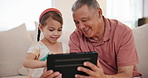 Happy, tablet and grandfather with child on sofa networking on social media in the living room at home. Smile, love and senior man in retirement bond, relax and scroll on digital technology with kid.