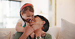 Grandmother, girl and embrace with smile, couch and kid with love, grandchild and home. Woman, happy and lounge or bonding together for relationship, family and playful with child, house and caring
