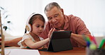 Tablet, homework and girl with grandfather for education, online learning and studying in home. School, family and young child with grandparent on digital tech for teaching and help with assessment 
