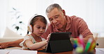 Online learning, homework and child with grandfather on tablet for education, elearning and studying in home. School, family and young girl with grandparent for teaching, knowledge and help for test 