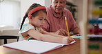 Writing, homework and girl with grandfather for education, learning and studying together in home. School, family and young child with grandparent for teaching, bonding and help with assessment 
